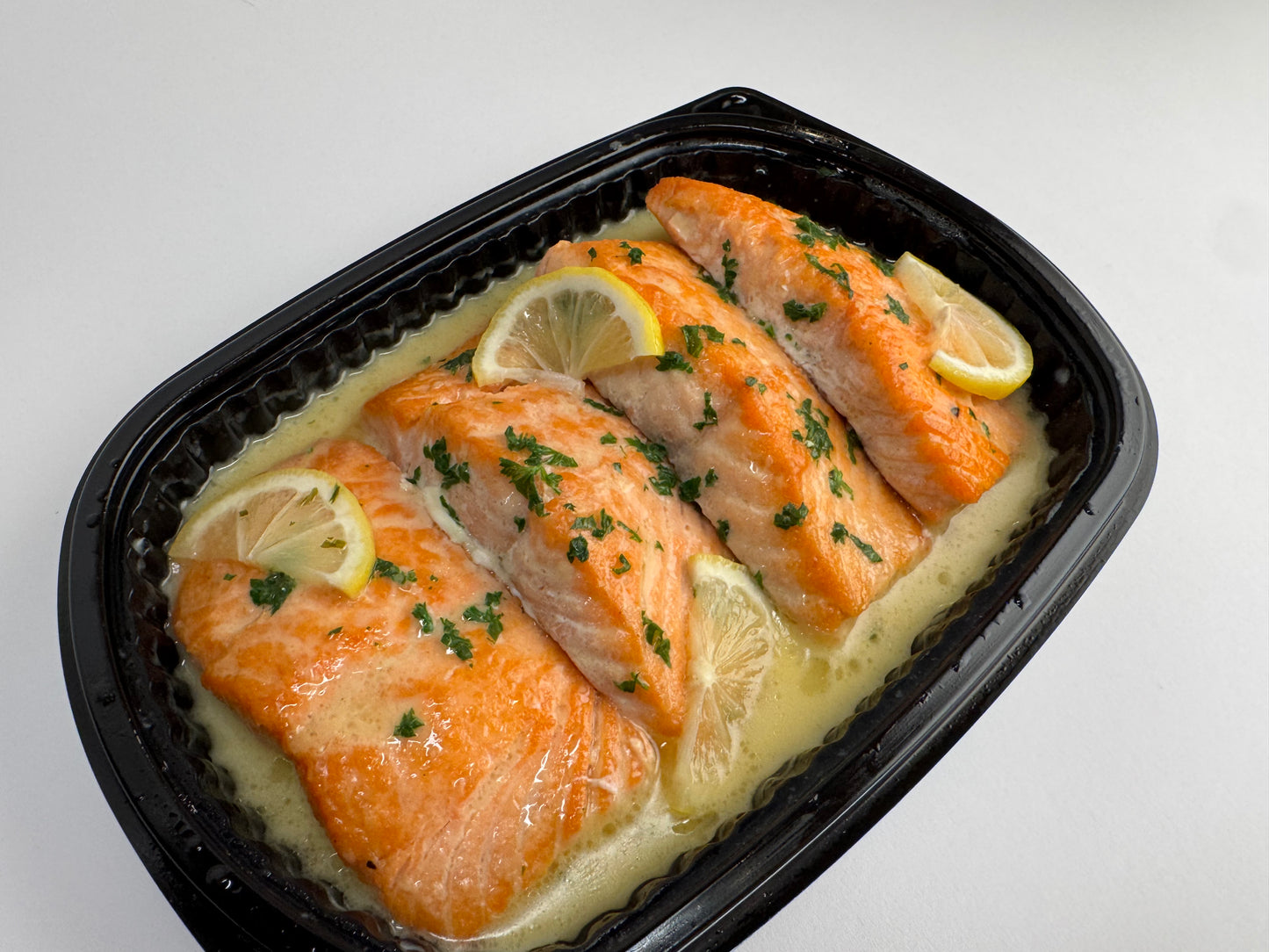 Freshly seared Salmon with lemon velouté paired with turmeric rice with pickled garlic and seasoned green beans with diced tomatoes