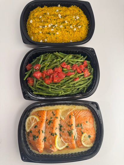 Freshly seared Salmon with lemon velouté paired with turmeric rice with pickled garlic and seasoned green beans with diced tomatoes