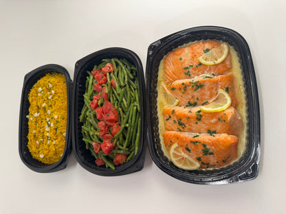 Freshly seared Salmon with lemon velouté paired with turmeric rice with pickled garlic and seasoned green beans with diced tomatoes