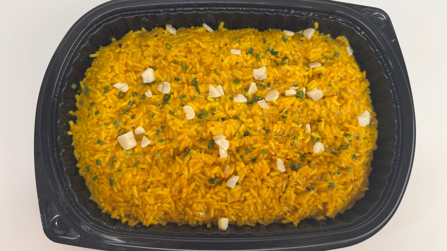 Freshly seared Salmon with lemon velouté paired with turmeric rice with pickled garlic and seasoned green beans with diced tomatoes