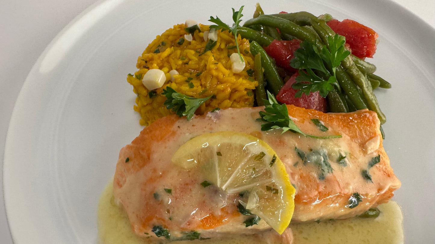 Freshly seared Salmon with lemon velouté paired with turmeric rice with pickled garlic and seasoned green beans with diced tomatoes
